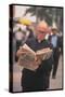 Episcopalian Priest Reading a Newspaper While Walking in Street, New York City-Vernon Merritt III-Stretched Canvas