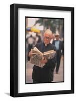 Episcopalian Priest Reading a Newspaper While Walking in Street, New York City-Vernon Merritt III-Framed Photographic Print