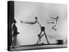 Erik Flensted Jensen, Coach of Danish Gymnastic Team, Watching as Three Men Perform-Gjon Mili-Stretched Canvas