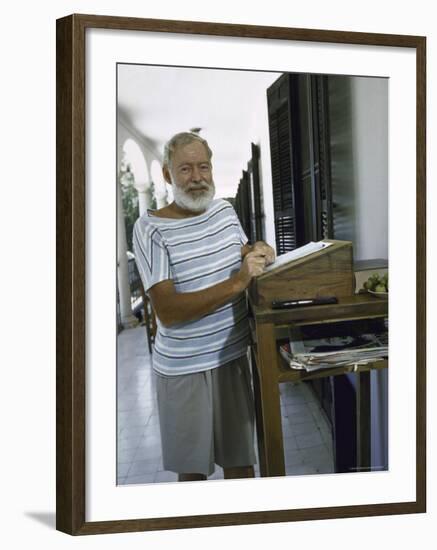 Ernest Hemingway at the Standing Desk on the Balcony of Bill Davis's Home Near Malaga-Loomis Dean-Framed Premium Photographic Print