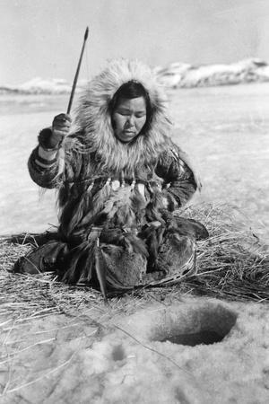 Eskimo Woman Fishing through Ice in Alaska Photograph - Alaska