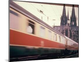 Eurailpass in Europe: Germany's Parsifal Express Speeding Past Cologne Cathedral-Carlo Bavagnoli-Mounted Photographic Print