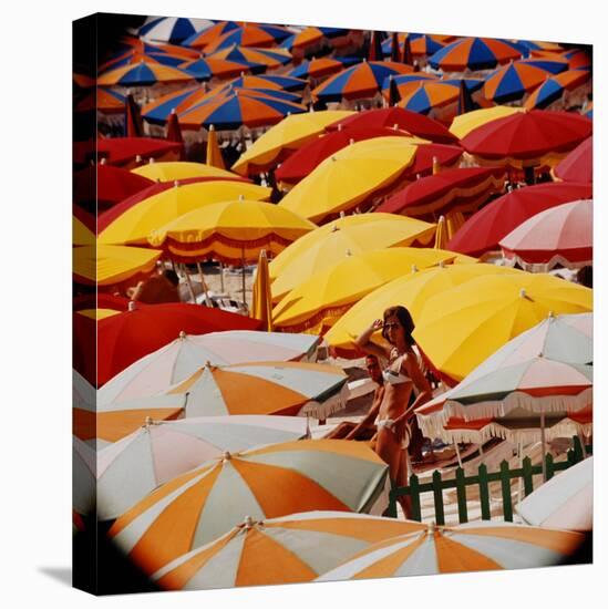 Europe Beach Scene Crowded with Colorful Umbrellas and a Bikini-Clad Young Woman-Ralph Crane-Stretched Canvas