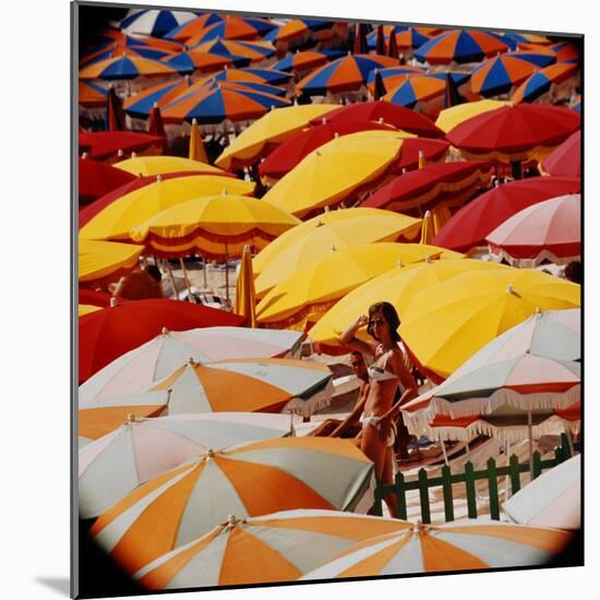 Europe Beach Scene Crowded with Colorful Umbrellas and a Bikini-Clad Young Woman-Ralph Crane-Mounted Photographic Print