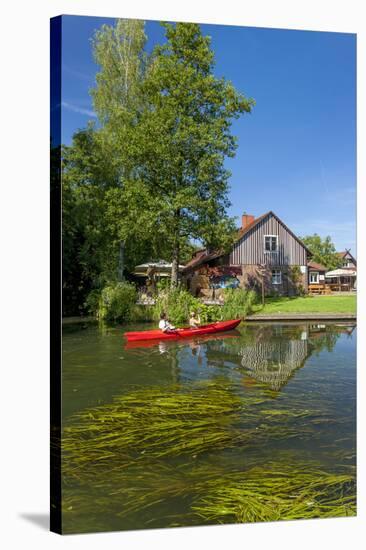 Europe, Germany, Brandenburg, Spreewald, Leipe, Traditional Houses at Water Channel, Canoeists-Chris Seba-Stretched Canvas