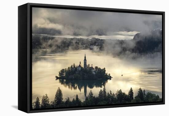 Europe, Slovenia, Bled - A Pletna Boat Arriving At The Island Of Lake Bled During A Foggy Sunrise-Aliaume Chapelle-Framed Stretched Canvas