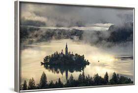 Europe, Slovenia, Bled - A Pletna Boat Arriving At The Island Of Lake Bled During A Foggy Sunrise-Aliaume Chapelle-Framed Photographic Print