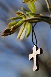 Pendant with cross on a young green chestnut leaf at springtime-null-Giclee Print