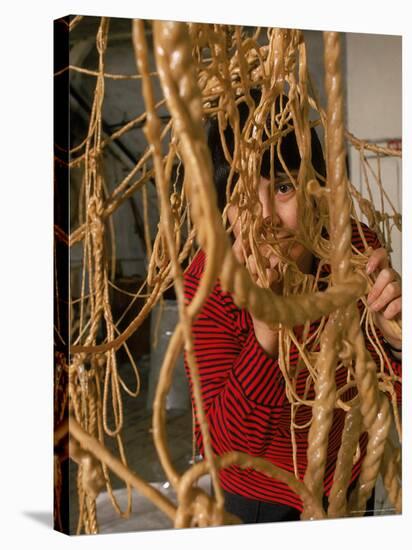 Eva Hesse Peering Through Her Sculpture of Rubber Dipped String and Rope-Henry Groskinsky-Stretched Canvas