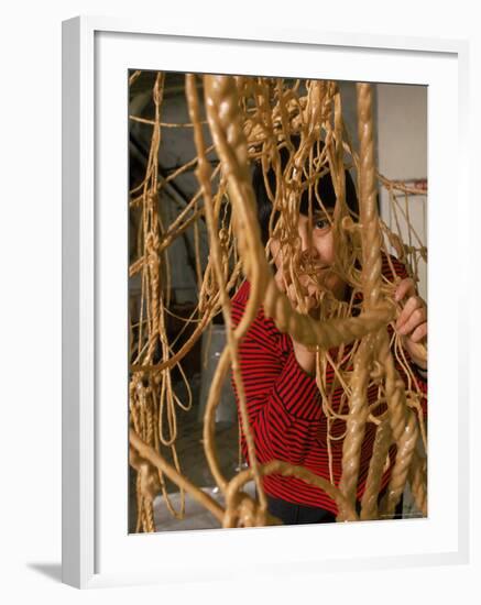 Eva Hesse Peering Through Her Sculpture of Rubber Dipped String and Rope-Henry Groskinsky-Framed Premium Photographic Print