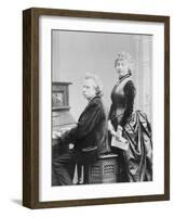 Evard Grieg Playing Piano with Wife Looking On-null-Framed Photographic Print