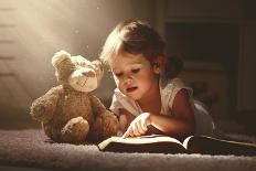 Child Little Girl Reading a Magic Book in the Dark Home with a Toy Teddy Bear-evgeny atamanenko-Photographic Print