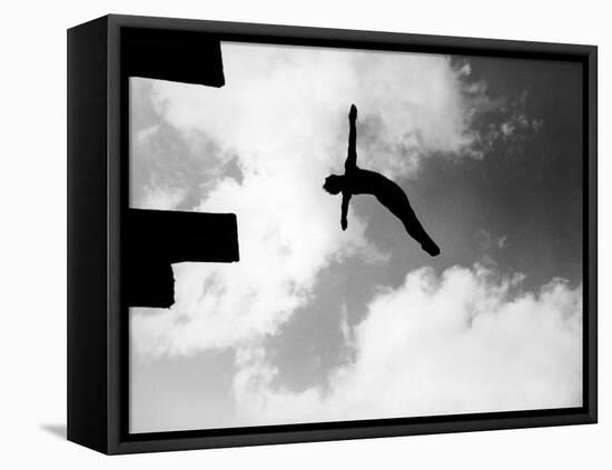 Excellent of Man Silhouetted Against Sky Doing Back Dive Off High Board-Rex Hardy Jr.-Framed Stretched Canvas