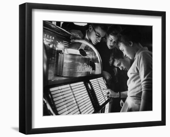 Exchange Student Stephen Lapekas Playing a Song on a Juke Box-null-Framed Photographic Print