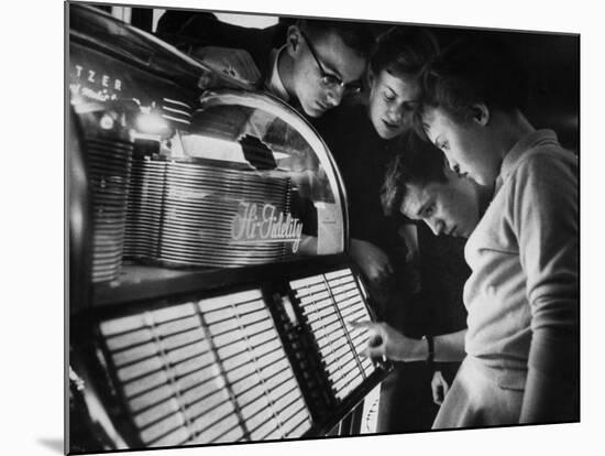 Exchange Student Stephen Lapekas Playing a Song on a Juke Box-null-Mounted Photographic Print