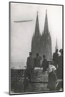 Excited Spectators Watching a Zeppelin Z111 Fly Over Cologne Cathedral Germany-null-Mounted Photographic Print