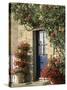 Exterior of a Blue Door Surrounded by Red Flowers, Roses and Geraniums, St. Cado, Brittany, France-Ruth Tomlinson-Stretched Canvas