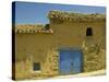 Exterior of an Adobe House with a Tile Roof and Blue Door, Salamanca, Castile Leon, Spain-Michael Busselle-Stretched Canvas