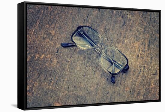 Eyeglasses Laying on a Grungy Wooden Background with Retro Filter Effect-Diplomedia-Framed Stretched Canvas