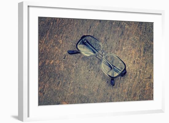 Eyeglasses Laying on a Grungy Wooden Background with Retro Filter Effect-Diplomedia-Framed Photographic Print