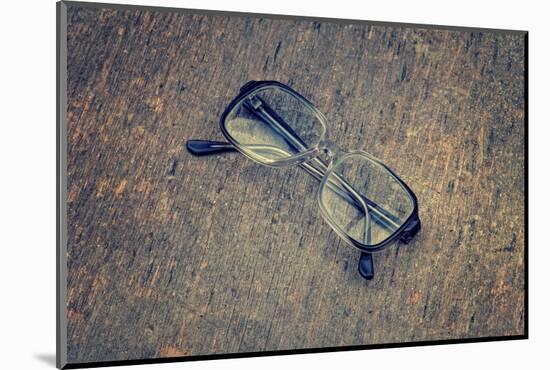 Eyeglasses Laying on a Grungy Wooden Background with Retro Filter Effect-Diplomedia-Mounted Photographic Print