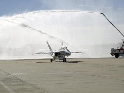 https://imgc.allpostersimages.com/img/posters/f-18-aircraft-taxies-beneath-the-spray-from-fire-trucks_u-L-P618550.jpg?artPerspective=n