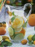 Jug of Water with Citrus Fruit, Lemon Balm and Ice Cubes-F. Strauss-Photographic Print