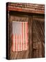 Faded American Flag on Old Barn Entrance, Maine, USA-Joanne Wells-Stretched Canvas