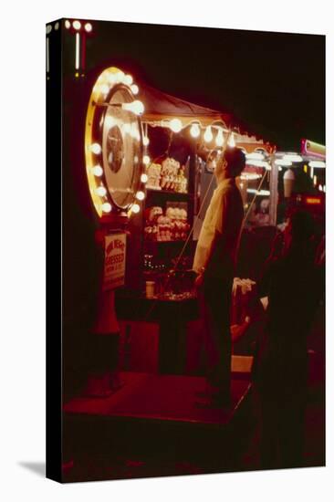 Fairgoer Stands on a 'Guess Your Weight' Carnival Game at the Iowa State Fair, 1955-John Dominis-Stretched Canvas