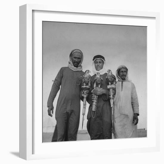 Falcon Trainers Holding onto Posts While their Birds Perch Atop Them-Bob Landry-Framed Photographic Print