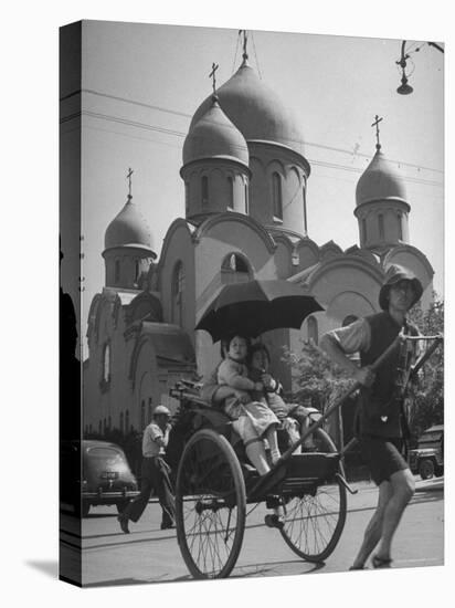 Family Being Pulled in a Rickshaw with a Russian Orthodox Church in the Background-Jack Birns-Stretched Canvas