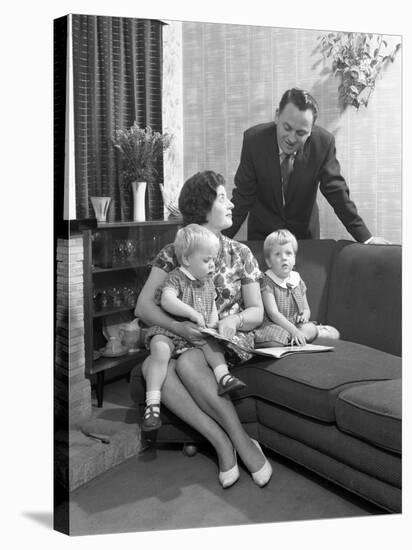 Family Group Looking at a Brochure, Doncaster, South Yorkshire, 1963-Michael Walters-Stretched Canvas