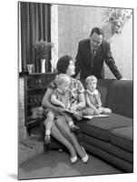 Family Group Looking at a Brochure, Doncaster, South Yorkshire, 1963-Michael Walters-Mounted Photographic Print