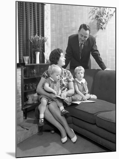 Family Group Looking at a Brochure, Doncaster, South Yorkshire, 1963-Michael Walters-Mounted Photographic Print