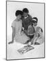 Family Group Looking at a Magazine, 1963-Michael Walters-Mounted Photographic Print