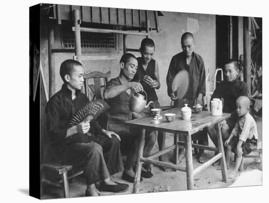 Family Having Tea in Courtyard-Carl Mydans-Stretched Canvas