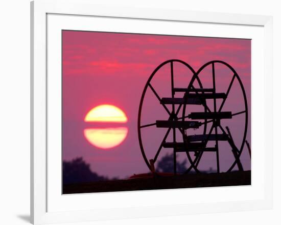 Farm Equipment is Silhouetted by a Setting Sun-null-Framed Photographic Print