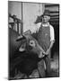 Farm Worker Petting One of the Cows Living on a Dairy Farm-Hansel Mieth-Mounted Photographic Print