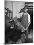 Farm Worker Petting One of the Cows Living on a Dairy Farm-Hansel Mieth-Mounted Photographic Print