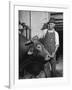 Farm Worker Petting One of the Cows Living on a Dairy Farm-Hansel Mieth-Framed Photographic Print