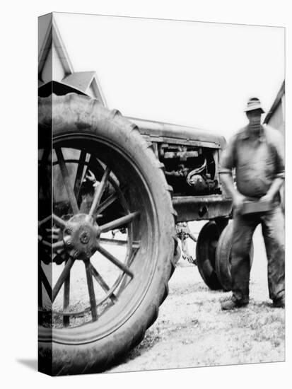 Farmer Is a Blur of Activity Working on His Tractor, Ca. 1938-null-Stretched Canvas