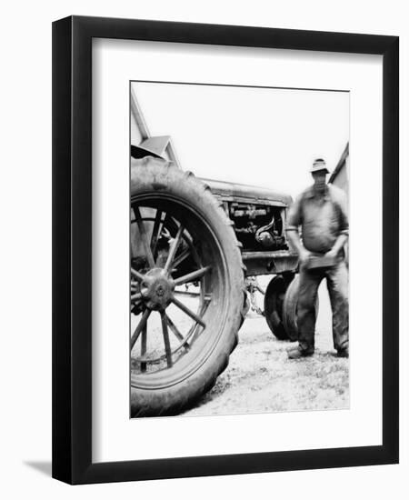 Farmer Is a Blur of Activity Working on His Tractor, Ca. 1938-null-Framed Premium Photographic Print