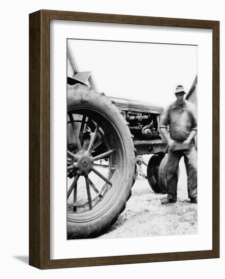 Farmer Is a Blur of Activity Working on His Tractor, Ca. 1938-null-Framed Photographic Print