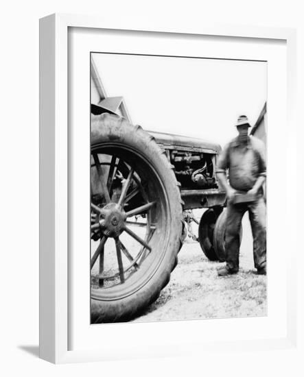 Farmer Is a Blur of Activity Working on His Tractor, Ca. 1938-null-Framed Photographic Print