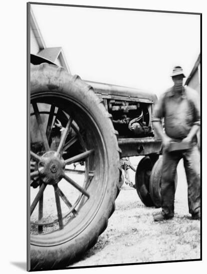 Farmer Is a Blur of Activity Working on His Tractor, Ca. 1938-null-Mounted Photographic Print