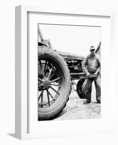 Farmer Is a Blur of Activity Working on His Tractor, Ca. 1938-null-Framed Photographic Print