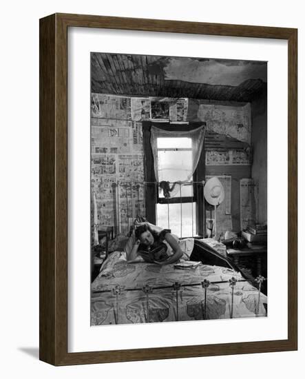 Farmer's Daughter Delphaline, Reading a Book as She Lies on Iron Bed in Her Bedroom-Alfred Eisenstaedt-Framed Photographic Print
