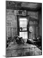 Farmer's Daughter Delphaline, Reading a Book as She Lies on Iron Bed in Her Bedroom-Alfred Eisenstaedt-Mounted Photographic Print