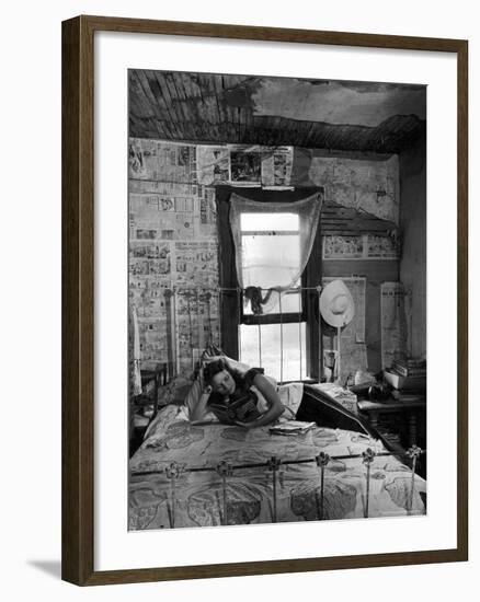 Farmer's Daughter Delphaline, Reading a Book as She Lies on Iron Bed in Her Bedroom-Alfred Eisenstaedt-Framed Photographic Print