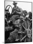 Farmer Sitting on Plow-null-Mounted Photographic Print